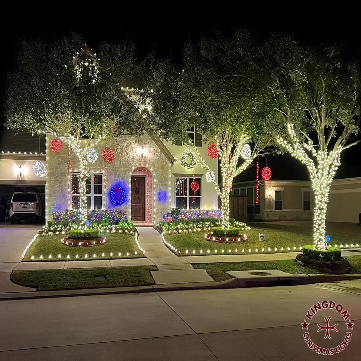 House decorated with Christmas lights and ornaments on a dark night.