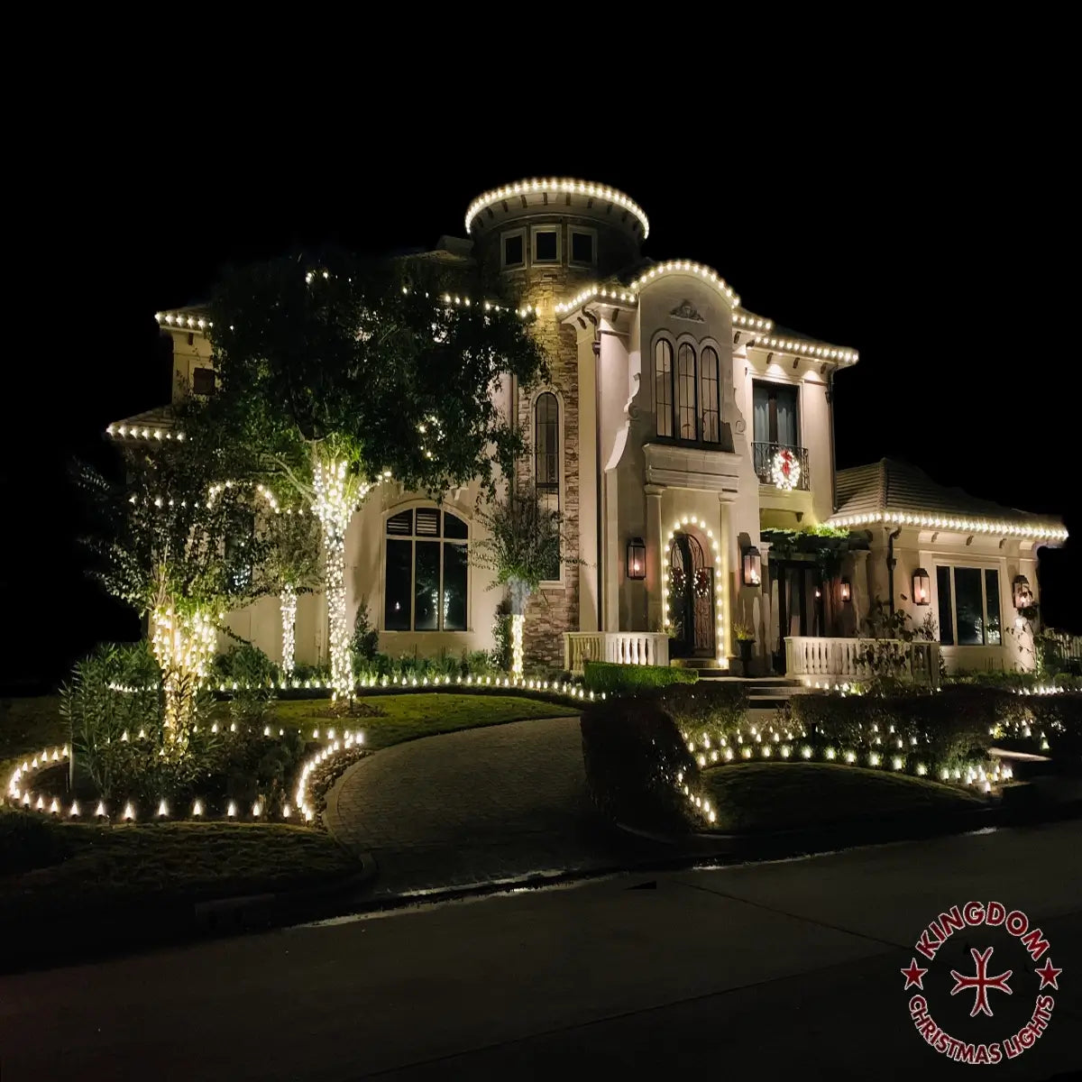 Kingdom Christmas Lights installation in Montgomery with warm-white rooflines, wrapped trees and illuminated landscape borders