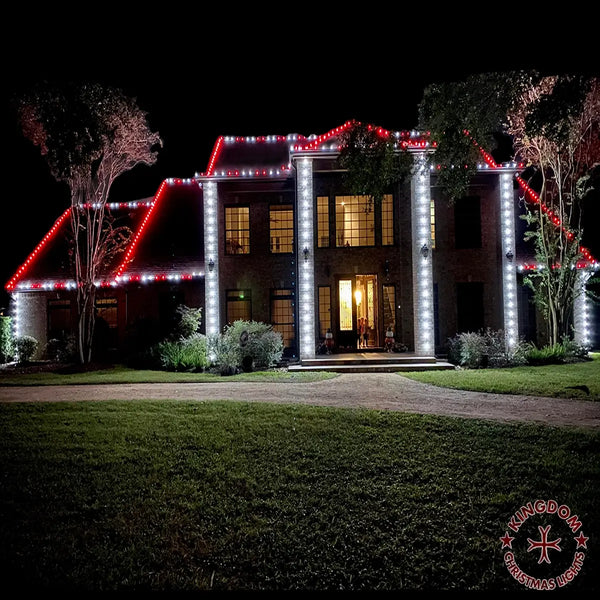 House exterior decorated with red and white lights at night