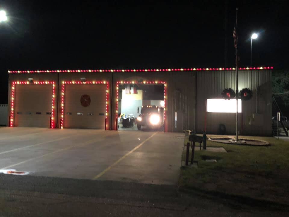 Fire station with red lights on the roof at night