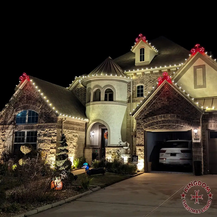 Christmas light installation service with warm white lights and red glitzer tips.