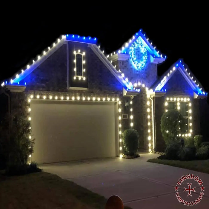 House exterior with Christmas lights at night, featuring Kingdom Christmas Lights logo.