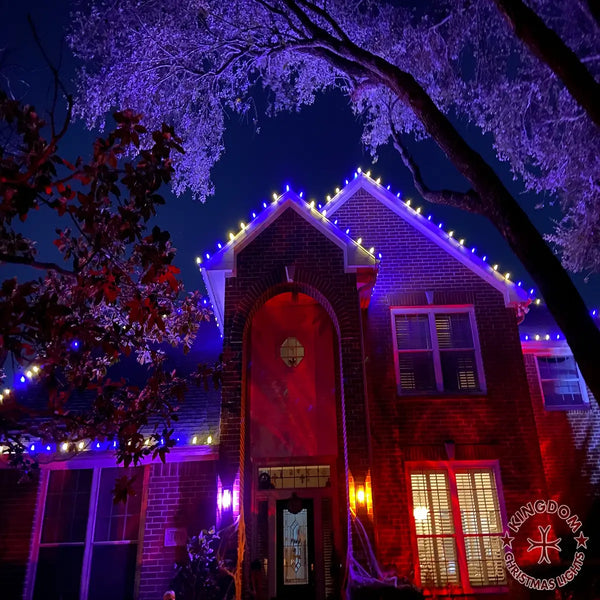 House exterior with festive lights and decorations against a dark sky