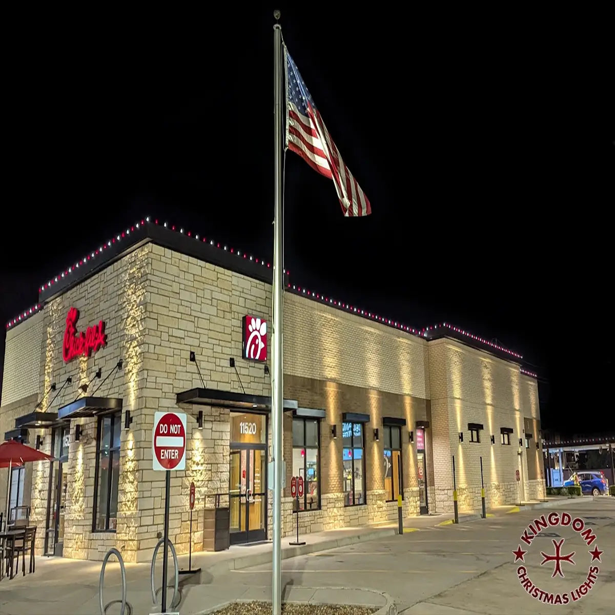 Burger King restaurant exterior at night with American flag and Kingdom Christmas Lights logo.