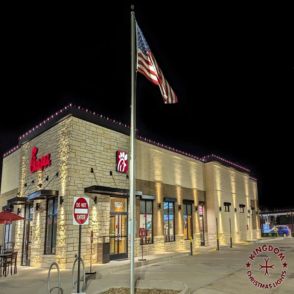 Burger King restaurant exterior at night with American flag and Kingdom Christmas Lights logo.