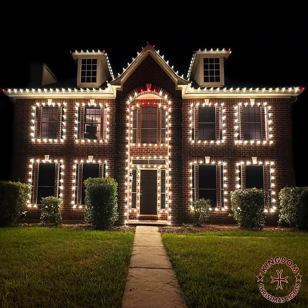 Brick house decorated with Christmas lights at night