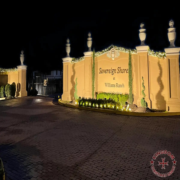 Entrance sign for 'Sovereign Shore at Williams Ranch' with decorative elements at night.