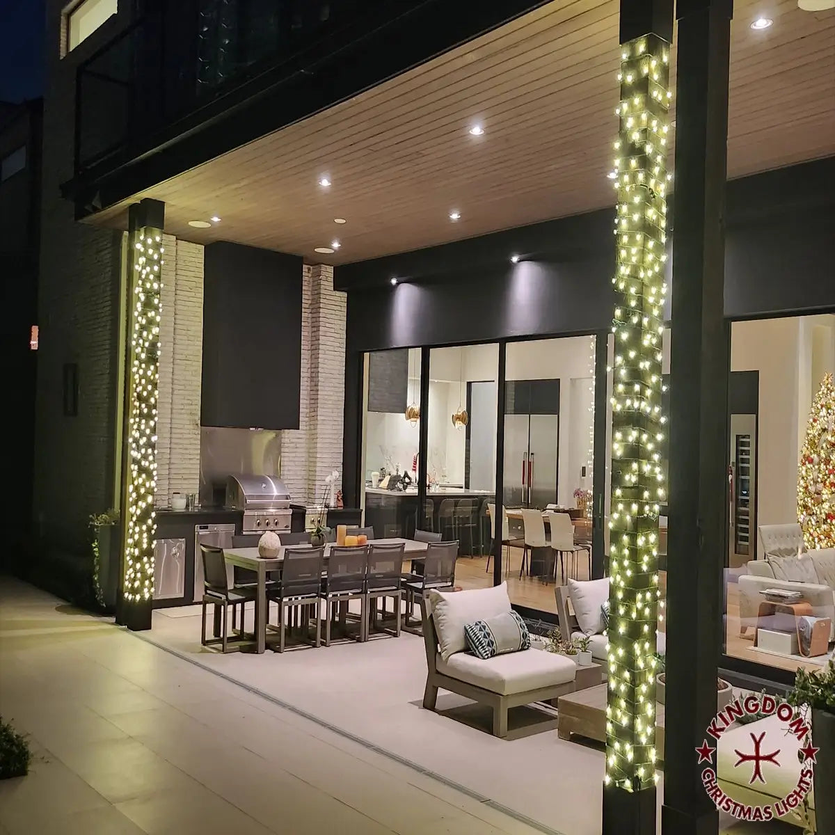 Outdoor patio with warm string lights and miniature lights around support columns