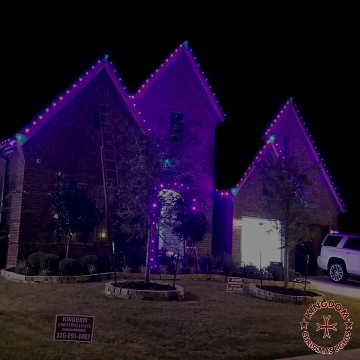 House with purple Christmas lights on a dark night