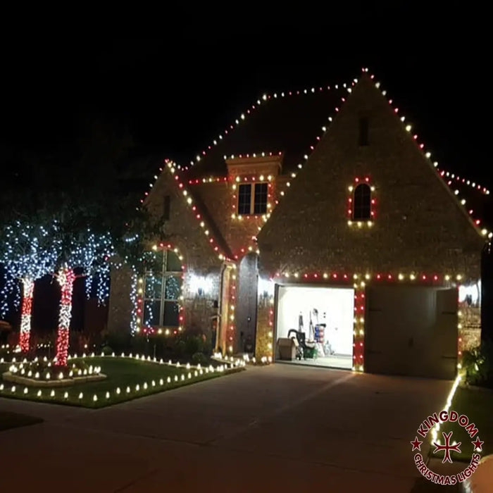 House exterior decorated with Christmas lights at night
