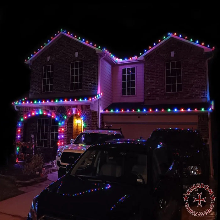 House decorated with colorful Christmas lights at night