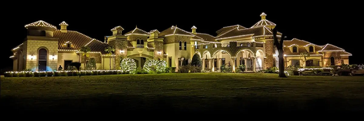 Luxurious mansion with illuminated exterior at night