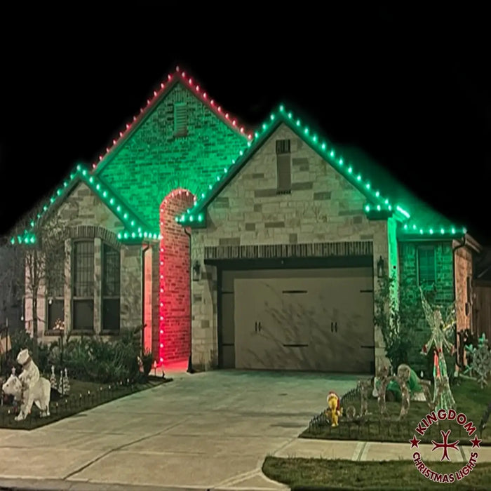 House with green and red Christmas lights on a dark night