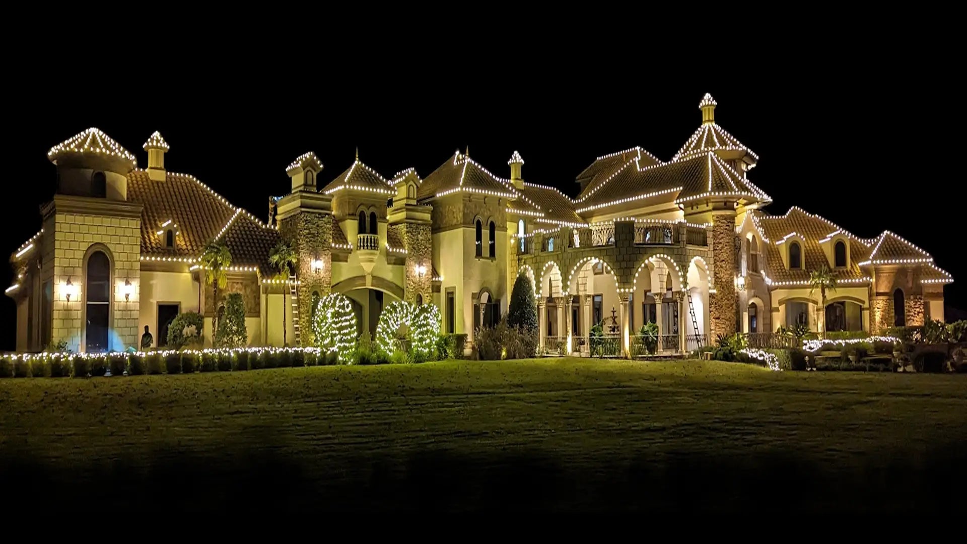 Luxurious mansion with decorative lights at night