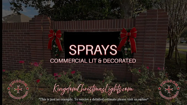 Commercial lit and decorated sign with red bows on a brick wall, featuring 'Sprays' and 'Kingdom Christmas Lights' branding.